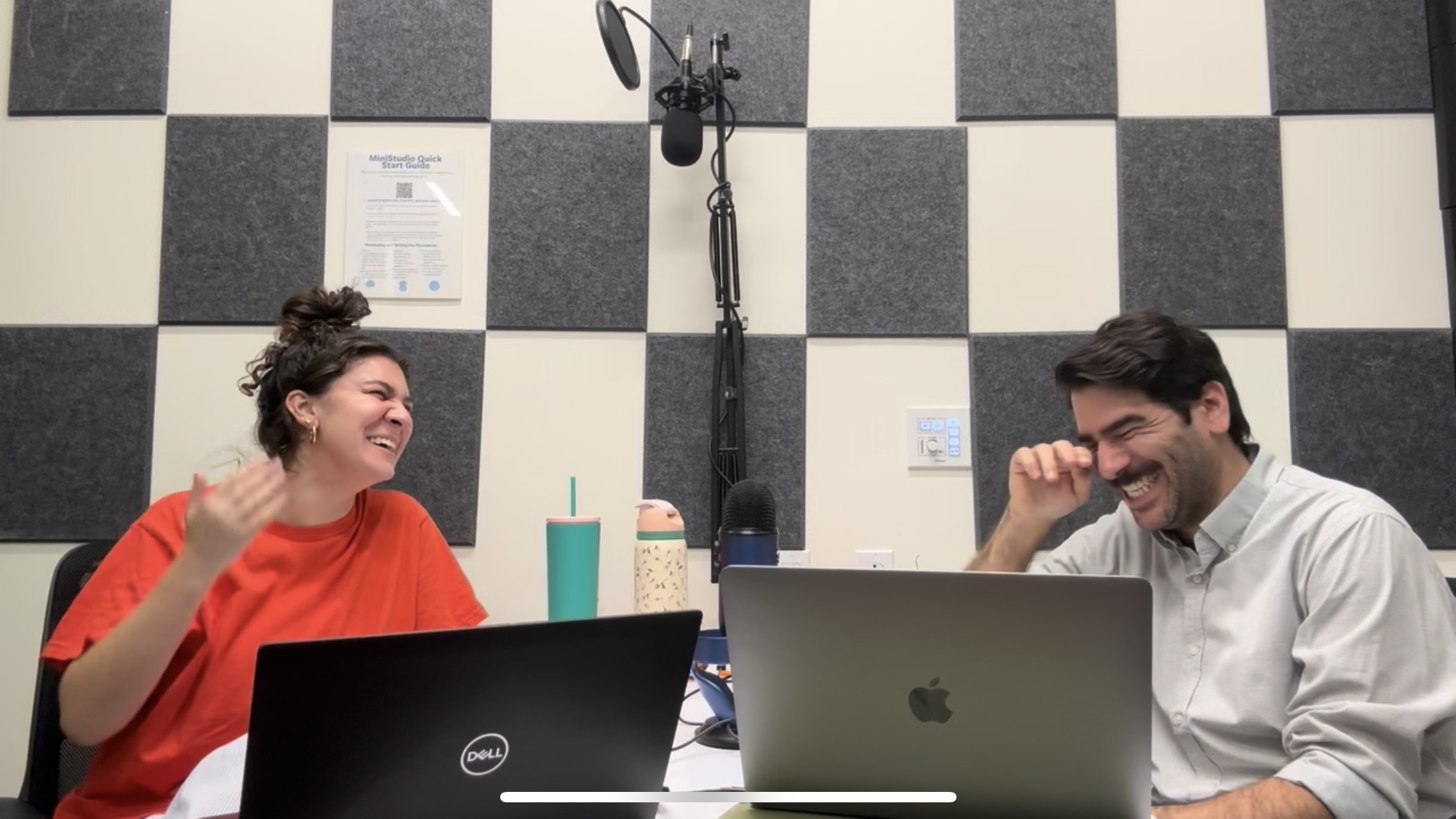 Nina Riffaud and Peter Young laugh while recording the podcast.